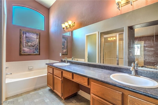 full bath featuring double vanity, a shower stall, a sink, and a bath