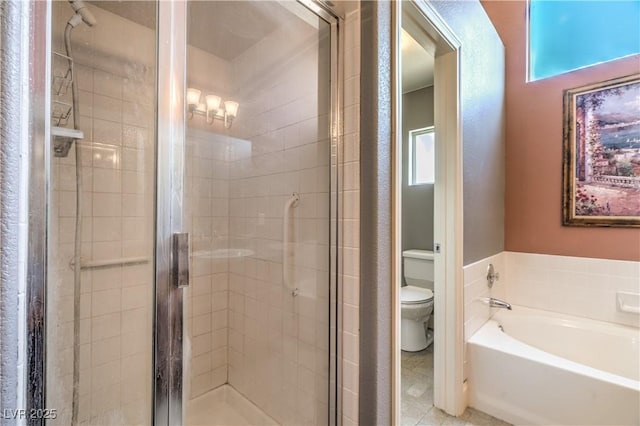 bathroom with a stall shower, toilet, and a bath