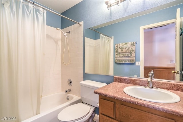 full bathroom featuring vanity, shower / bath combination with curtain, and toilet