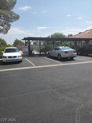 uncovered parking lot featuring fence