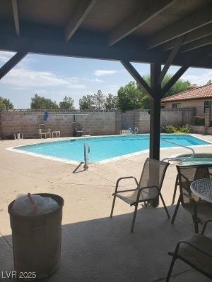 community pool featuring a patio and a fenced backyard