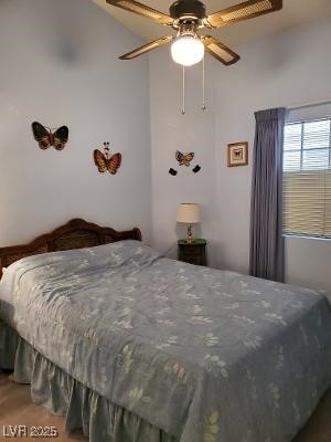 bedroom with ceiling fan and a towering ceiling