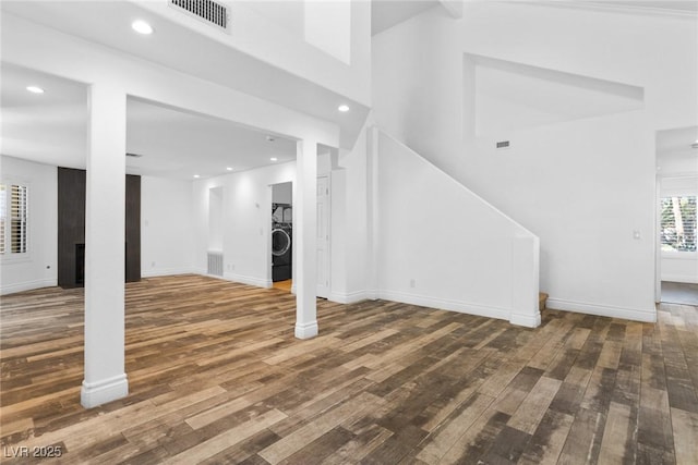 basement featuring visible vents, wood finished floors, baseboards, washer / clothes dryer, and recessed lighting