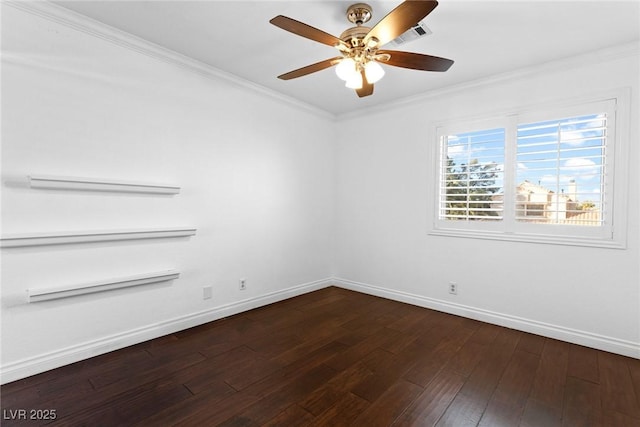 spare room featuring a ceiling fan, visible vents, dark wood finished floors, baseboards, and ornamental molding