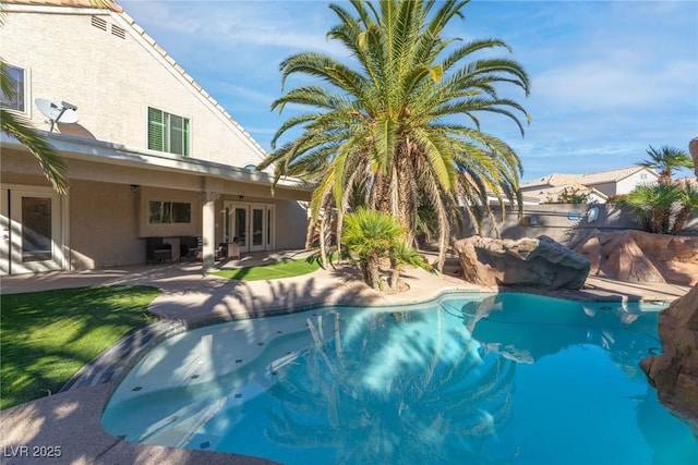 view of swimming pool featuring a fenced in pool, a patio area, fence, and french doors