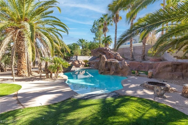 view of swimming pool featuring a fenced in pool, a fenced backyard, an outdoor fire pit, and a patio
