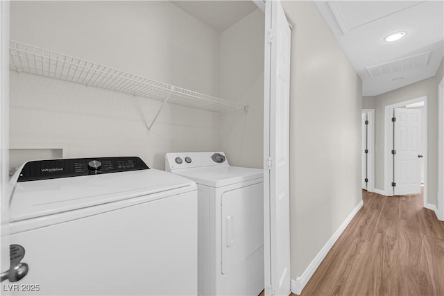 laundry room with laundry area, visible vents, light wood-type flooring, baseboards, and separate washer and dryer