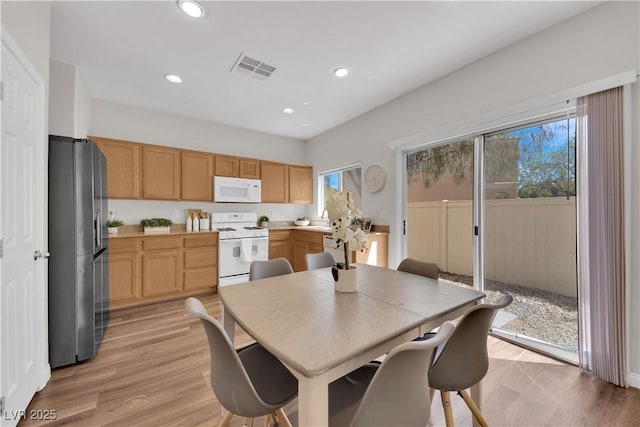 dining area with visible vents, recessed lighting, and light wood-style flooring