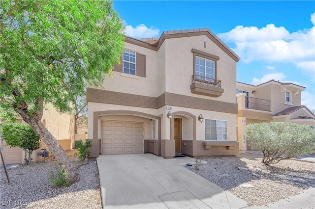 mediterranean / spanish-style home featuring an attached garage, concrete driveway, and stucco siding