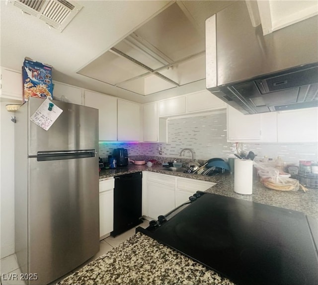 kitchen featuring ventilation hood, freestanding refrigerator, white cabinetry, black dishwasher, and visible vents