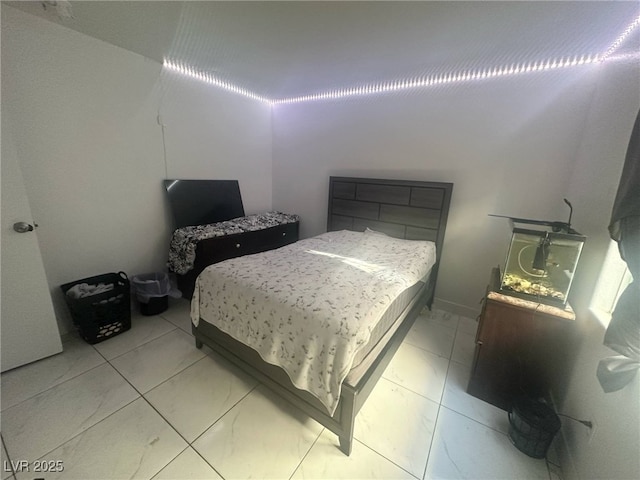 bedroom featuring marble finish floor