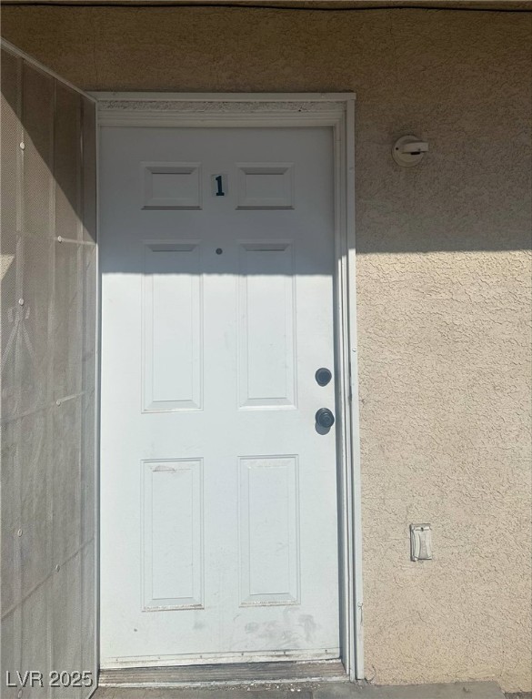 doorway to property with stucco siding