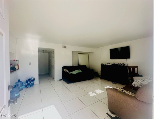 living room with light tile patterned flooring and visible vents