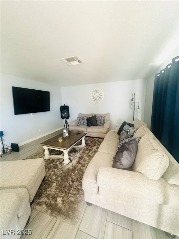 living room with visible vents and wood finished floors