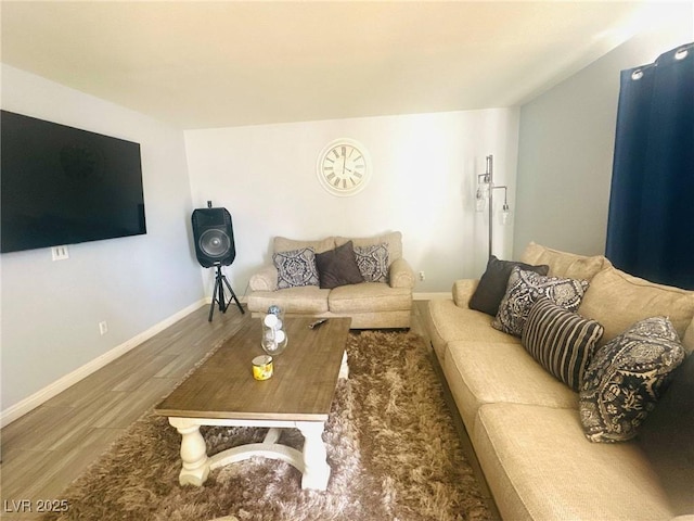living area featuring baseboards and wood finished floors