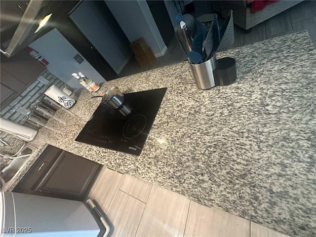 room details featuring wood finished floors and black electric cooktop