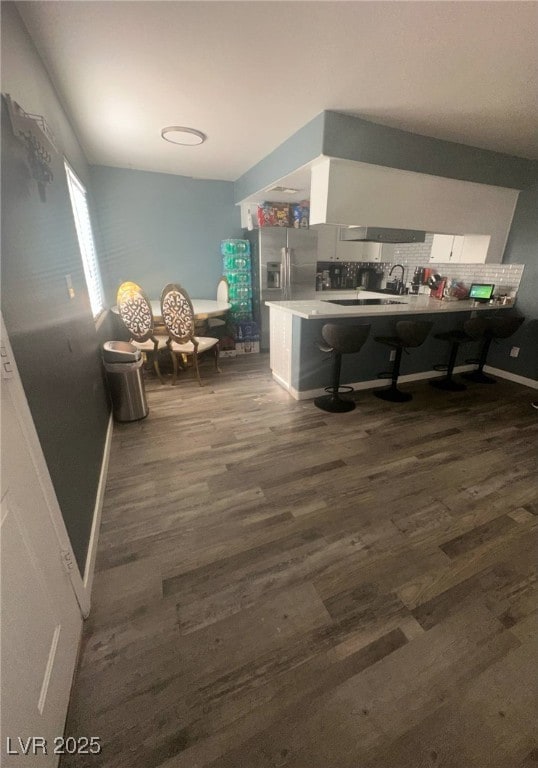 interior space featuring baseboards and dark wood finished floors