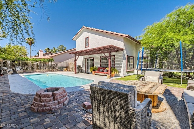 view of swimming pool featuring a pergola, a trampoline, a fenced in pool, a patio area, and a fire pit