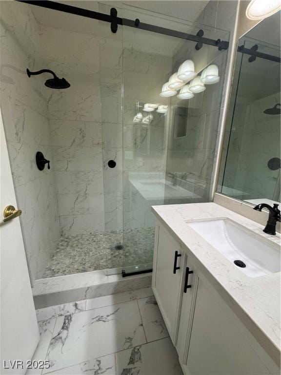 bathroom with vanity, marble finish floor, and a stall shower