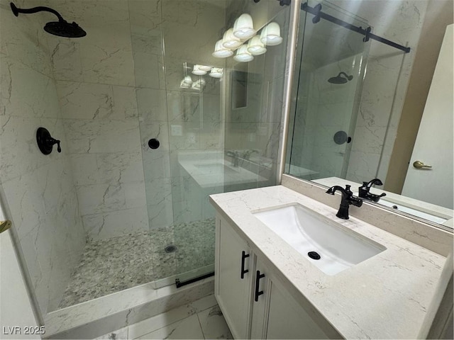full bathroom with a marble finish shower, marble finish floor, and vanity