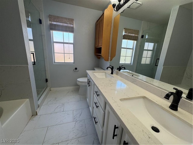 bathroom with toilet, a sink, and marble finish floor