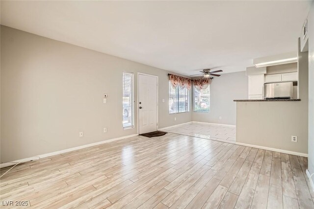 4955 Lindell Rd Unit 130, Las Vegas, NV 89118 - unfurnished living room featuring ceiling fan, light wood finished floors, and baseboards
