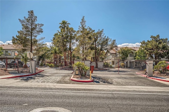 4955 Lindell Rd Unit 130, Las Vegas, NV 89118 - view of property hidden behind natural elements featuring a gate and a residential view