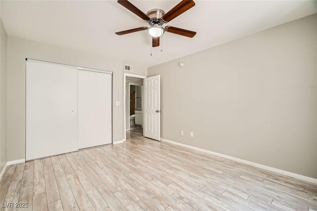 4955 Lindell Rd Unit 130, Las Vegas, NV 89118 - unfurnished bedroom featuring light wood-style flooring, a closet, and baseboards