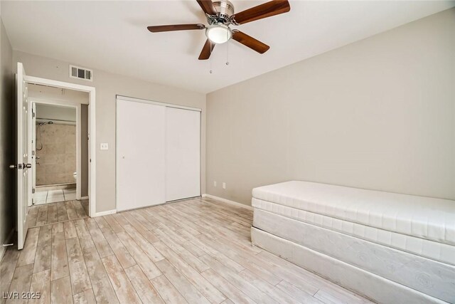 4955 Lindell Rd Unit 130, Las Vegas, NV 89118 - bedroom with light wood finished floors, a closet, baseboards, and a ceiling fan