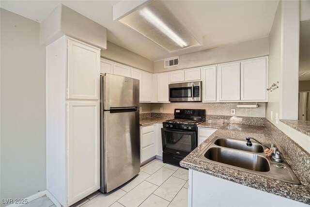 4955 Lindell Rd Unit 130, Las Vegas, NV 89118 - kitchen featuring stainless steel appliances, a sink, white cabinetry, and light marble finish floors