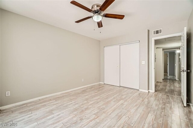 4955 Lindell Rd Unit 130, Las Vegas, NV 89118 - unfurnished bedroom with light wood-style flooring, a closet, baseboards, and a ceiling fan
