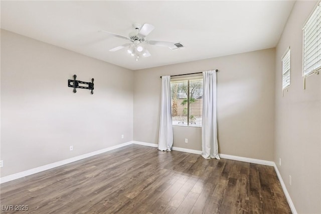 spare room featuring baseboards, a ceiling fan, and wood finished floors