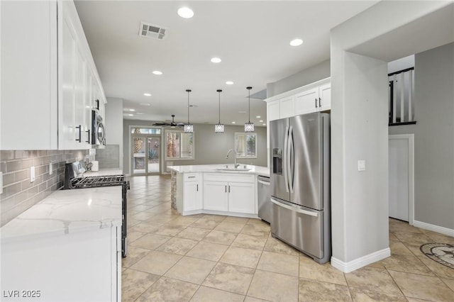 kitchen with a sink, stainless steel appliances, white cabinetry, a peninsula, and visible vents