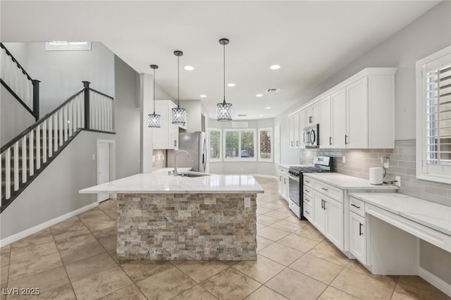 kitchen with stainless steel appliances, recessed lighting, white cabinetry, light tile patterned floors, and backsplash