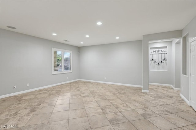 basement with light tile patterned floors, baseboards, and recessed lighting
