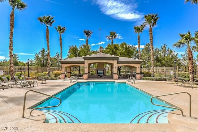 pool featuring a gazebo, fence, and a patio area