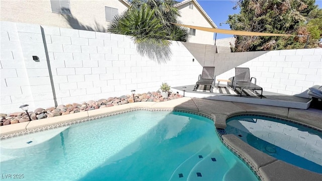 view of pool with an outdoor hot tub, a fenced in pool, a fenced backyard, and a patio area