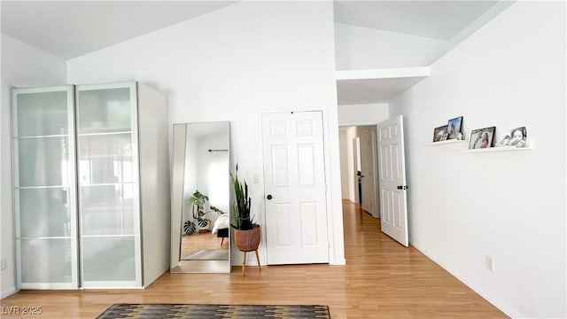 interior space featuring light wood-style floors and vaulted ceiling