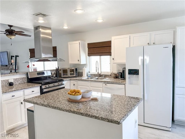 kitchen featuring white appliances, white cabinetry, a sink, and range hood