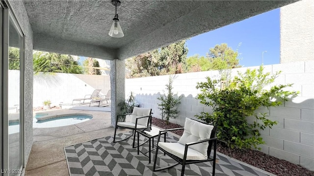 view of patio featuring a fenced backyard and an in ground hot tub