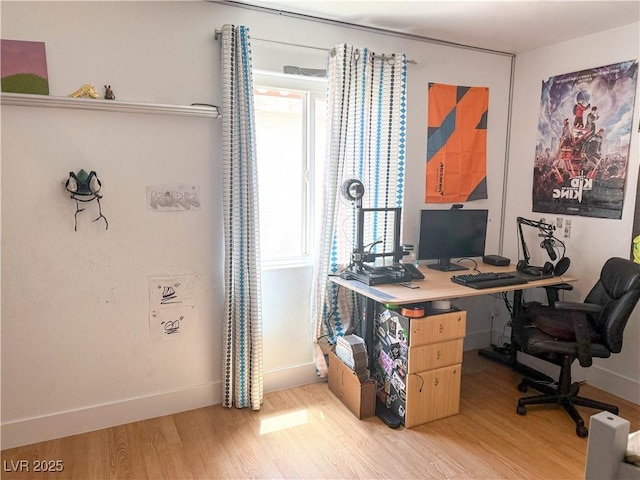 office featuring baseboards and light wood-style flooring