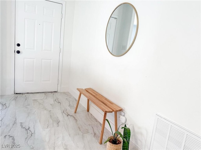 hall with baseboards, visible vents, and marble finish floor