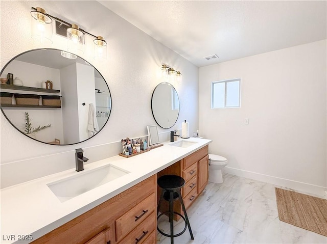 bathroom with double vanity, a sink, marble finish floor, and visible vents
