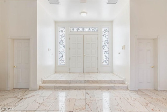 entrance foyer with visible vents, marble finish floor, and a healthy amount of sunlight