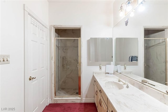 bathroom with a marble finish shower and vanity