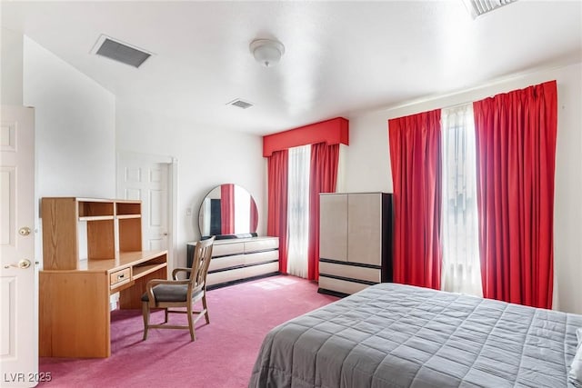 bedroom with visible vents and carpet