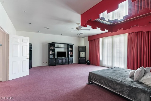 carpeted bedroom with visible vents and a ceiling fan