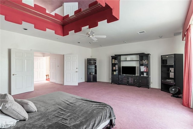 carpeted bedroom featuring baseboards, a ceiling fan, and visible vents