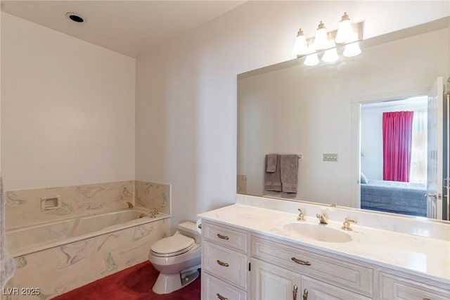 full bathroom featuring toilet, a garden tub, and vanity