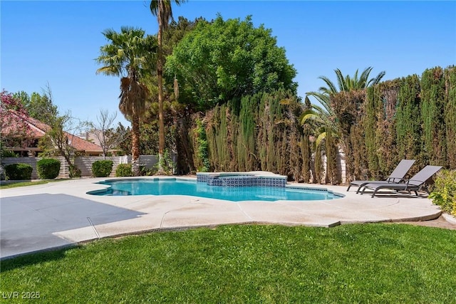 view of swimming pool with fence, a yard, a patio area, and a pool with connected hot tub